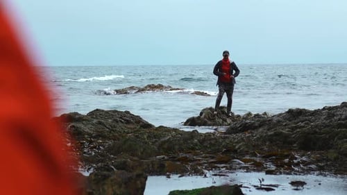 Woman Dances Standing on Rocks in Water of Sea Clip Woman Happily Dances Standing on Rocks of