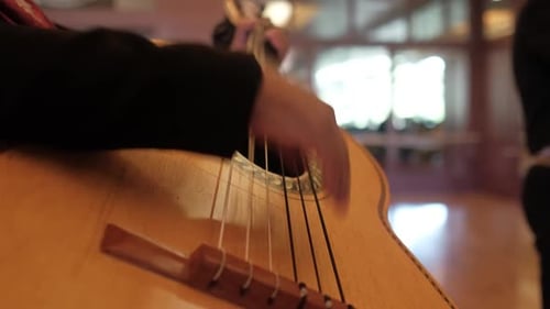 Close up of mariachi charro playing guitar