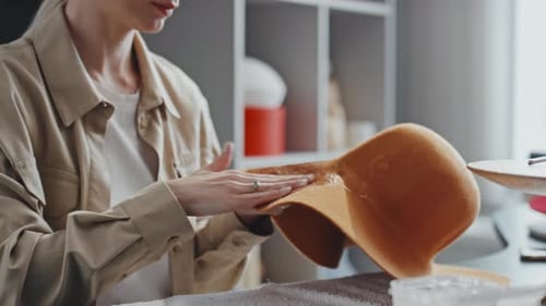 Woman Shapes Felt Hat in Workshop Studio