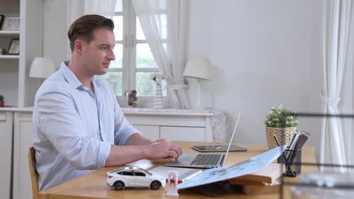 Car designer carefully analyzing car prototype. Fastidious