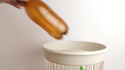E03 1. Leere Plastikflaschen werden in den Mülleimer geworfen. Entsorgung von Hausmüll.