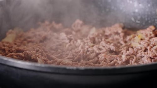 Sizzling Ground Meat Browning in Frying Pan