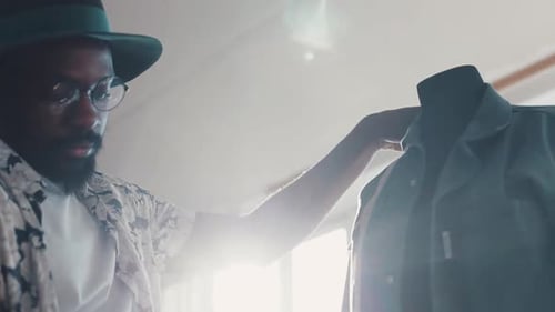 Man Measuring Garment on Mannequin in Studio