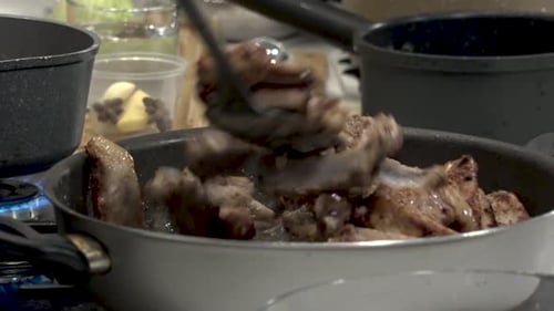 Meat Sizzling in a Pan Being Stirred