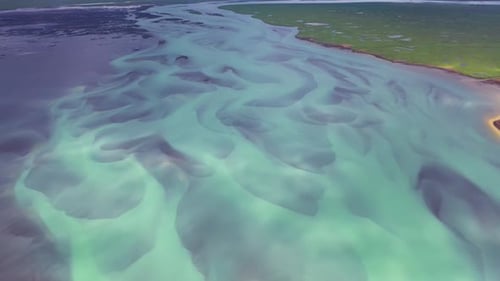 Aerial view of a water pattern background from a river estuary from above, Iceland.