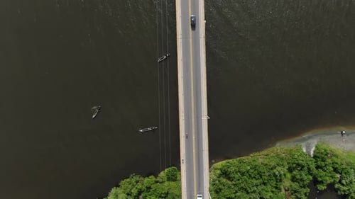 Heavy traffic on a two lane bridge connecting two islands.