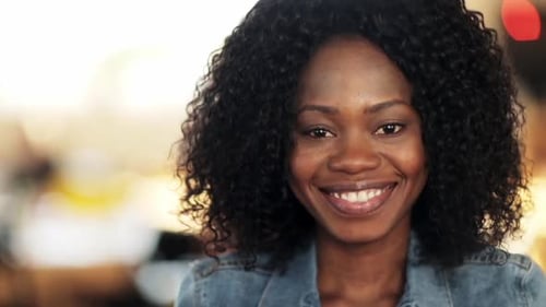 Smiling woman with curly hair looking at camera
