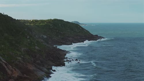 Lush Green Coastal Cliffs Meeting The Deep Blue Ocean Waves