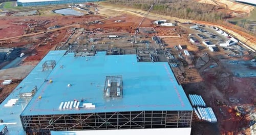During the Construction of Industrial Buildings Crawler Cranes are Used to Erect Metal Steel Framing