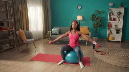 Woman Does Arm Workout on Exercise Ball at Home