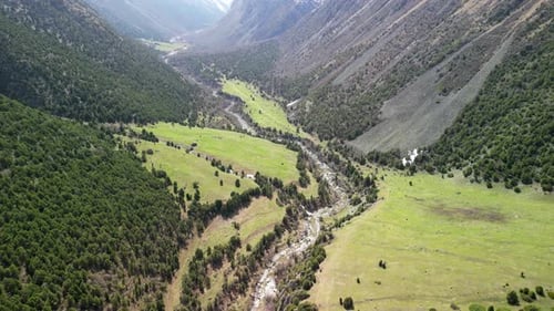 Alamedin Gorge, green valley with river, drone circling shot