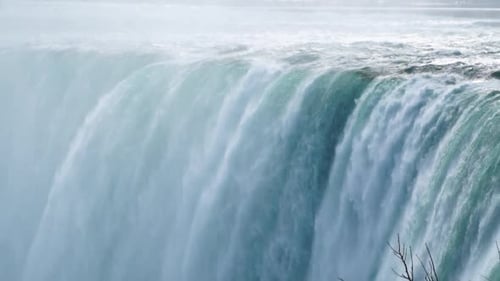 Panning Mid shot of Niagara falls crest and heavy mist Slow Motion