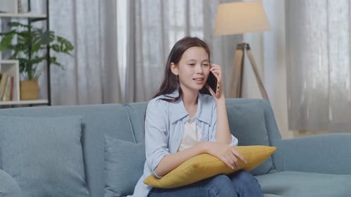 Woman Laughing, Talking on Cell Phone Indoors