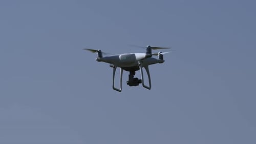 The drone hovers in flight on a bright sunny day, Drone hovering, Drone camera, quadcopters