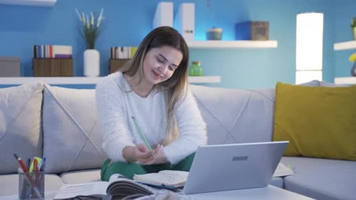Woman Studying and Working at Home on Couch