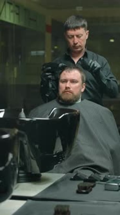Barber Cuts a Man's Hair in Barber Shop