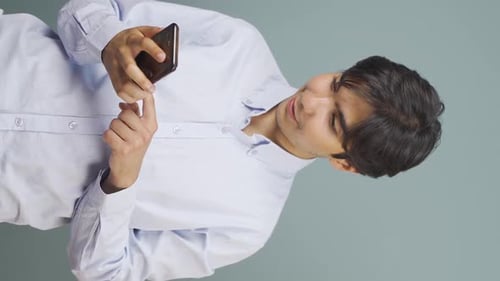 Young Man Reacts to Good News on Smartphone