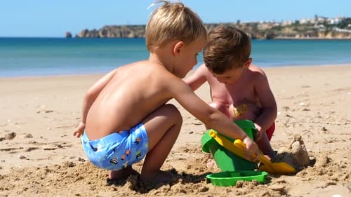 Two Adorable Young Boys Playing on the Beach, Summer Holiday SLOMO