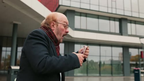 Man Sneezing with a Tissue in Urban Setting
