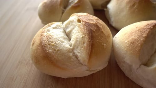 Golden Bread Rolls on a Wood Surface