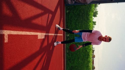 a Tall guy basketball player with the ball shows his dribbling skills during practice on the court