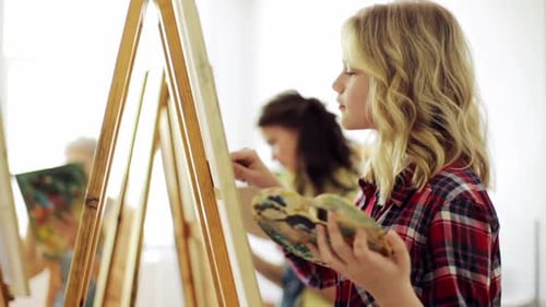 Art School, Creativity And People Concept - Group Of Students With Easels And Palette Knifes Pain...