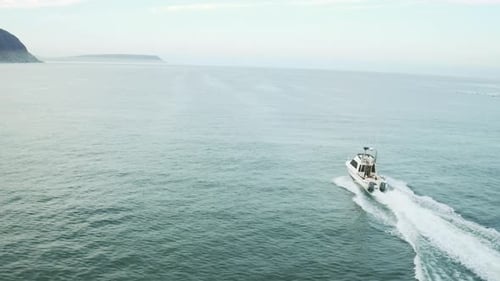 4k drone footage of a boat travelling across the sea