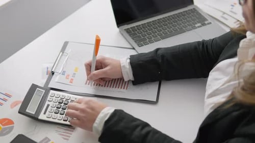 A Financial Analyst Keeps Records and Analyzes Data in the Workplace Using Modern Technology and a