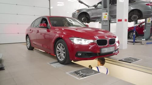 Mechanic Working on Car in Auto Service Garage