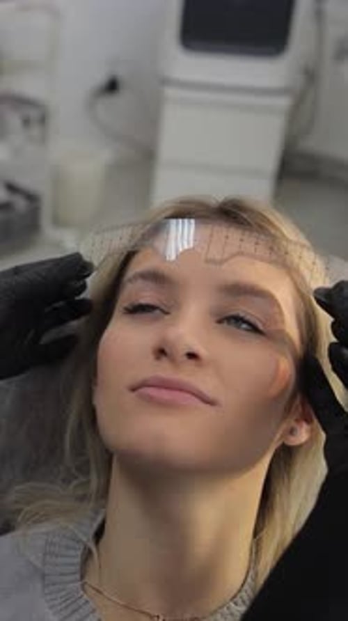 Skilled Professional Aesthetician Meticulously Shaping a Woman's Eyebrows in a Serene Spa Setting