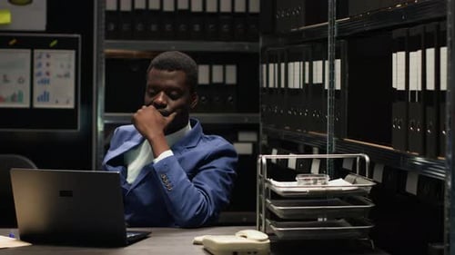 Man at Desk Processing Paperwork at Workplace