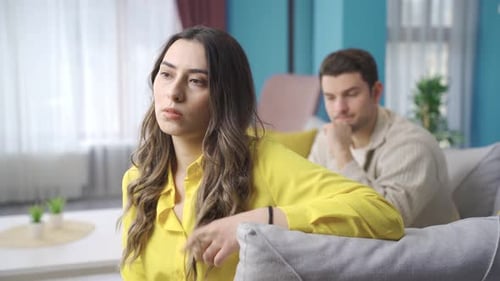Woman Receives Shoulder Massage From Man on Sofa