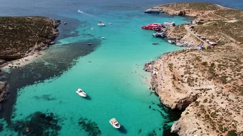 Aerial view of Blue Lagoon, Comino island, Malta. Turquoise water and tourist boat in the Mediterran