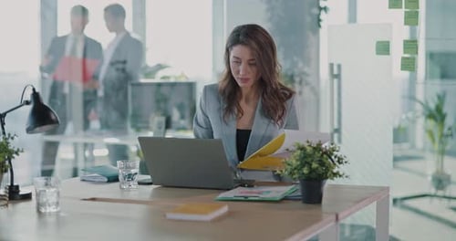 Young Woman Working at Laptop in Modern Office