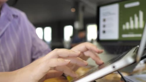 Young adult woman working on laptop computer in cafe