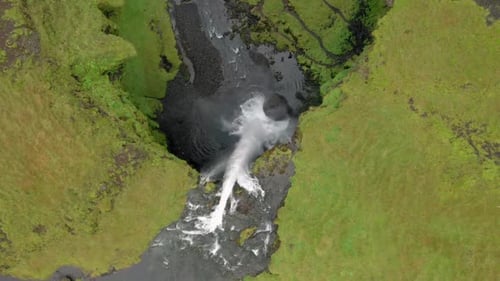 Winding River Feeds Seljalandsfoss Waterfall in Brown Icelandic Highlands.