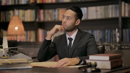 Pensive Middle Aged Lawyer Reading Book in Court