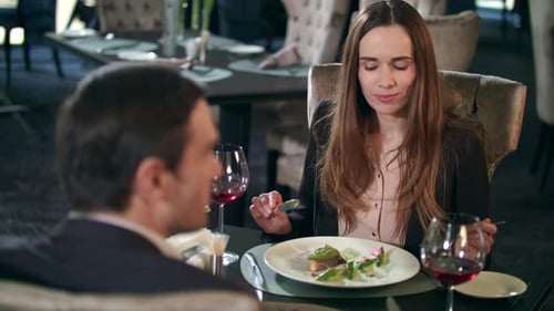 Business Woman Eating Food in Restaurant. Business Couple Dining Together in Cafe