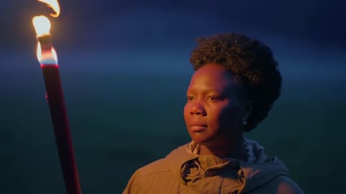 Woman with Torch in the Darkness