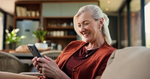Smiling Woman Using Smartphone Relaxing on Couch