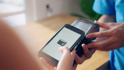 Close up of customer's hand scanning QR code to pay for deliverly food.