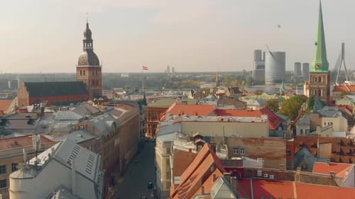Panorama of Riga old town rooftops on sunny day, pan left view