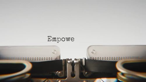 Old mechanical typewriter typing Empower Yourself in a close-up view.