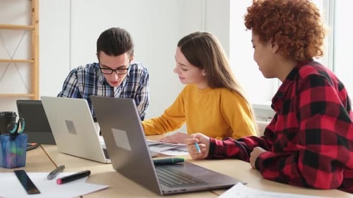 Young Adults Work Together in Bright Office