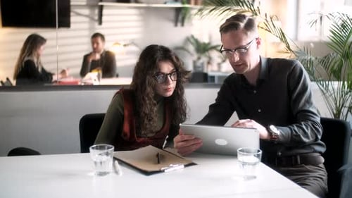 In Creative Office Productive Coworkers Standing at the Table Company Meeting Businessman And Woman