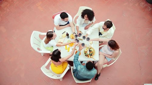 High Angle View of a Group of Friends Having a Dinner Party Celebration at Home Terrace Toasting or