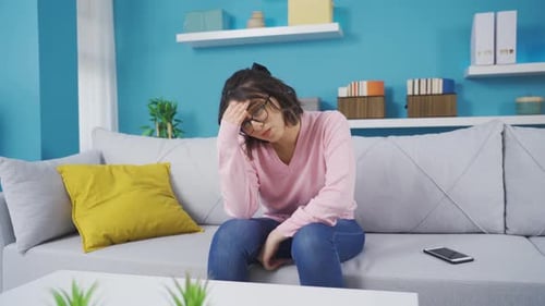 Angry and depressed young woman unhappy at home.