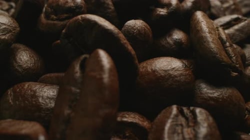 Super up close dolly from left to right video of roasted coffee beans.