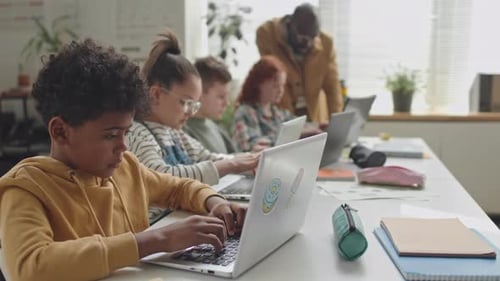 Diligent African American Schoolboy Coding on Laptop on Lesson