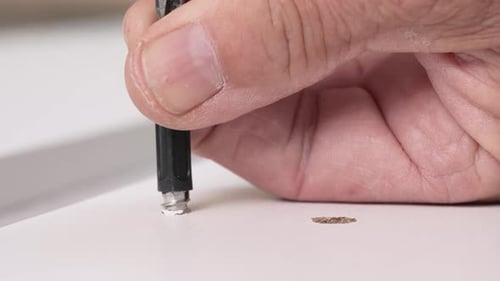 Connector Piece Screwed Into Wood With Screwdriver